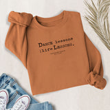 Dance Lessons are Life Lessons sweatshirt in yam – flat lay style from MusicWorks